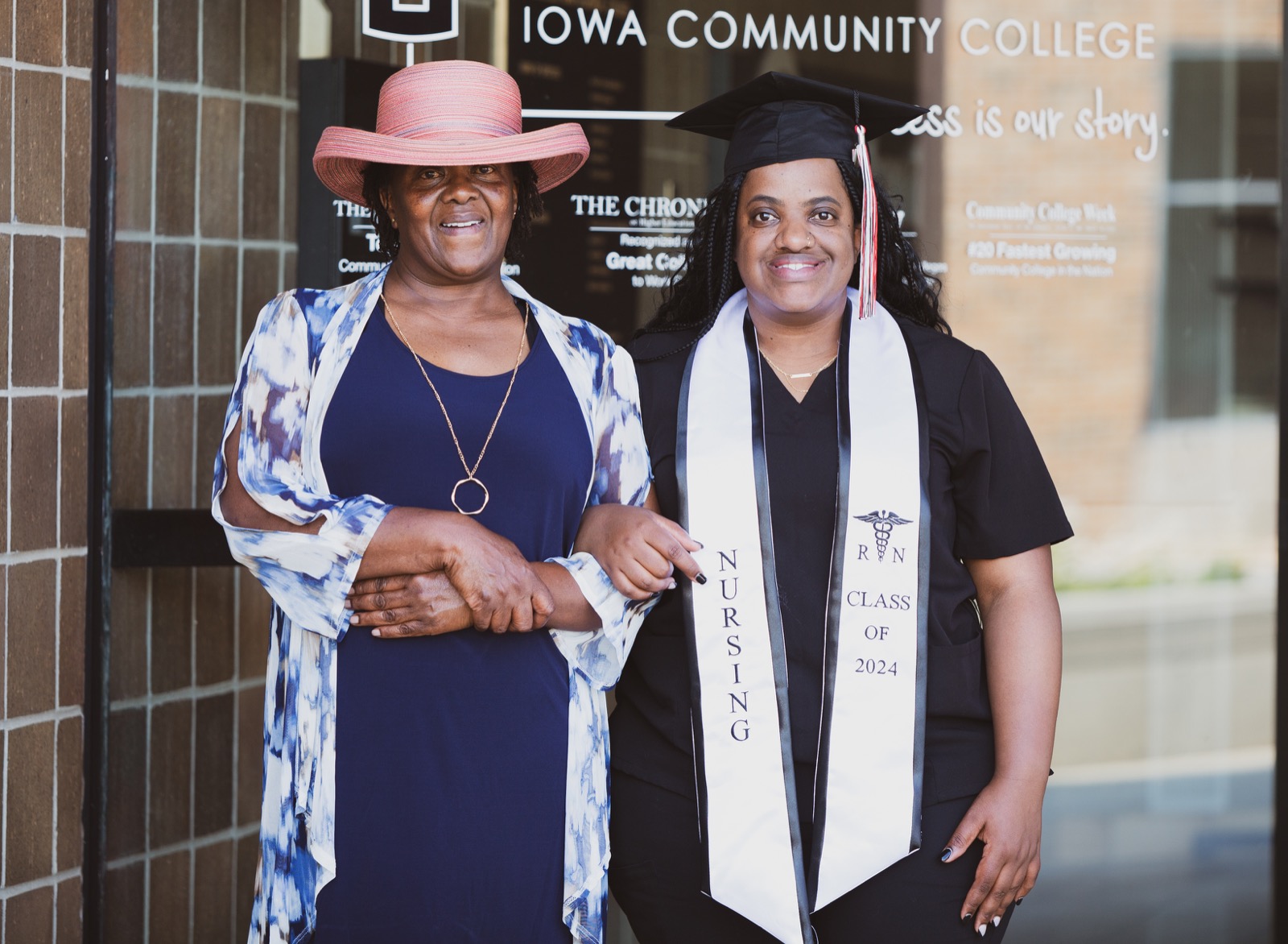New nursing graduate celebrating with her mother outside the college